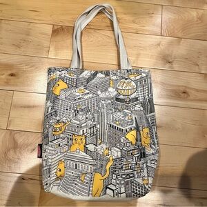 Get a piece of New York—Strand Books Yellow Cat Cityscape Tote Bag